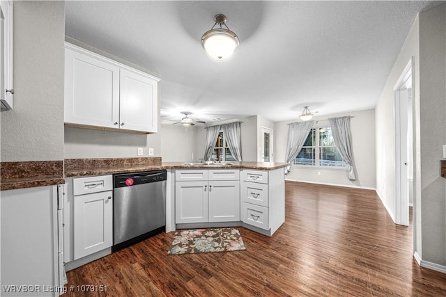 kitchen featuring dark wood-style floors, stainless steel dishwasher, open floor plan, white cabinetry, and a peninsula