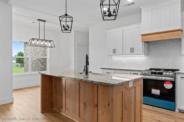 1317 Big Oak Dr, Alma, AR 72921 - kitchen featuring stainless steel gas range, backsplash, visible vents, and light wood-style floors