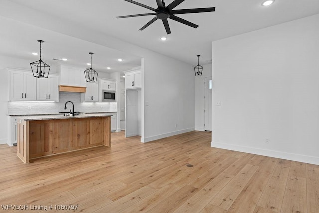 1317 Big Oak Dr, Alma, AR 72921 - kitchen featuring white cabinets, backsplash, ceiling fan with notable chandelier, and a sink