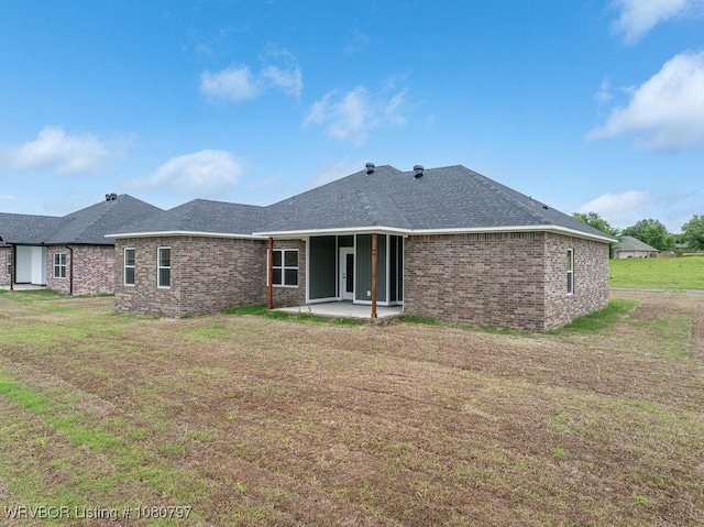 1317 Big Oak Dr, Alma, AR 72921 - rear view of house featuring a lawn, roof with shingles, a patio, and brick siding
