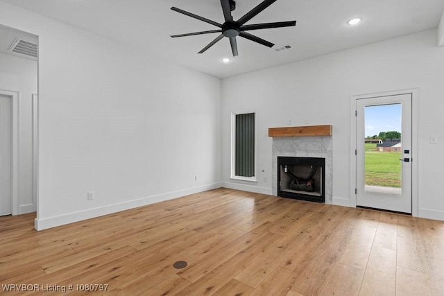 1317 Big Oak Dr, Alma, AR 72921 - unfurnished living room with ceiling fan, a tile fireplace, visible vents, and light wood-style floors