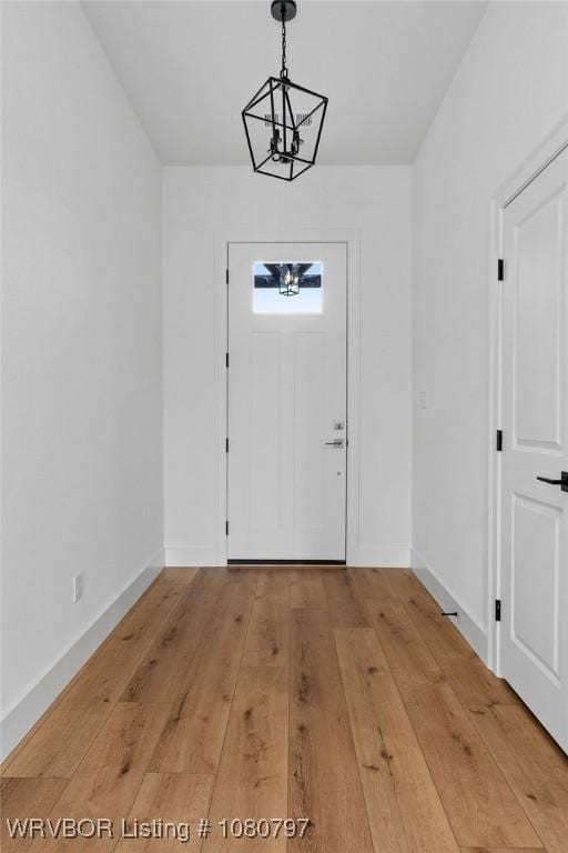1317 Big Oak Dr, Alma, AR 72921 - entrance foyer with light wood finished floors, an inviting chandelier, and baseboards