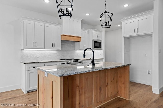 1317 Big Oak Dr, Alma, AR 72921 - kitchen with a sink, stainless steel appliances, light wood-style flooring, backsplash, and light stone countertops