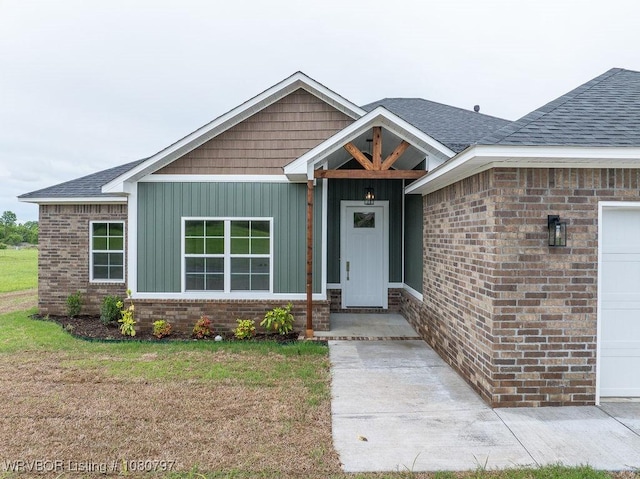 1317 Big Oak Dr, Alma, AR 72921 - view of front of property with a front lawn, board and batten siding, brick siding, and roof with shingles
