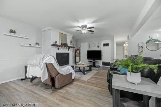 204 Cornell Ave, Fort Smith, AR 72908 - living area with light wood-style floors, ceiling fan, and a fireplace