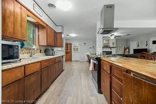 204 Cornell Ave, Fort Smith, AR 72908 - kitchen featuring light wood-type flooring, appliances with stainless steel finishes, plenty of natural light, and open floor plan