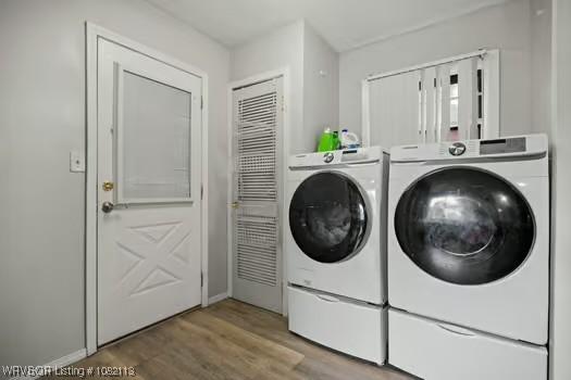 204 Cornell Ave, Fort Smith, AR 72908 - laundry area featuring washing machine and dryer and wood finished floors