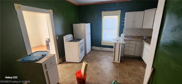 kitchen with white cabinetry, white appliances, and ornamental molding