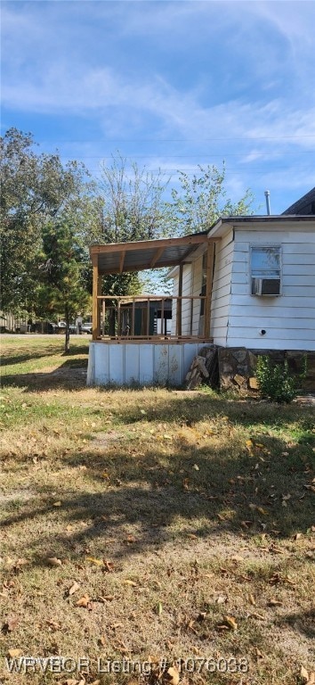 exterior space featuring cooling unit and a lawn