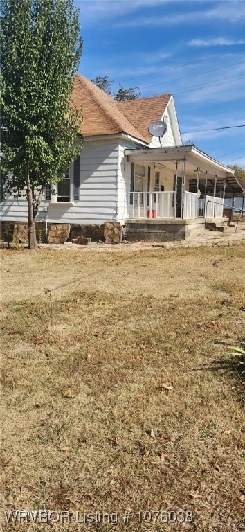 view of side of property featuring a porch