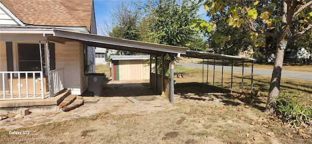 view of side of property with a carport and a storage shed