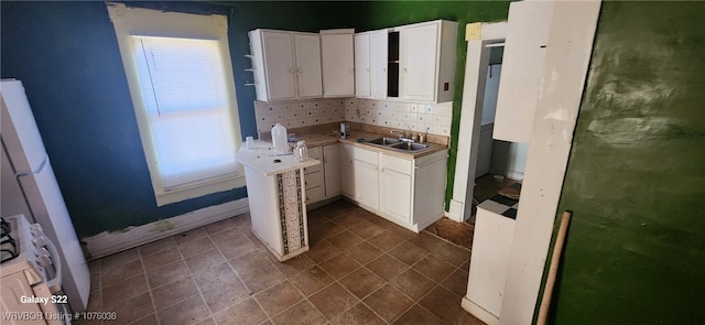 kitchen featuring white cabinetry and sink