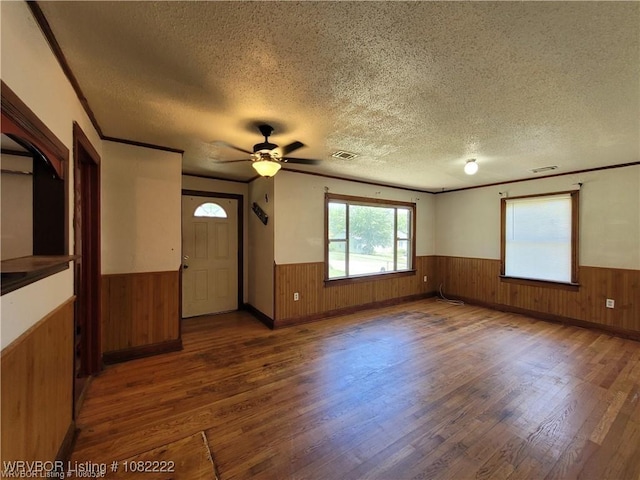1100 Dechard St, Van Buren, AR 72956 - unfurnished room featuring wainscoting, wooden walls, a textured ceiling, wood finished floors, and a ceiling fan