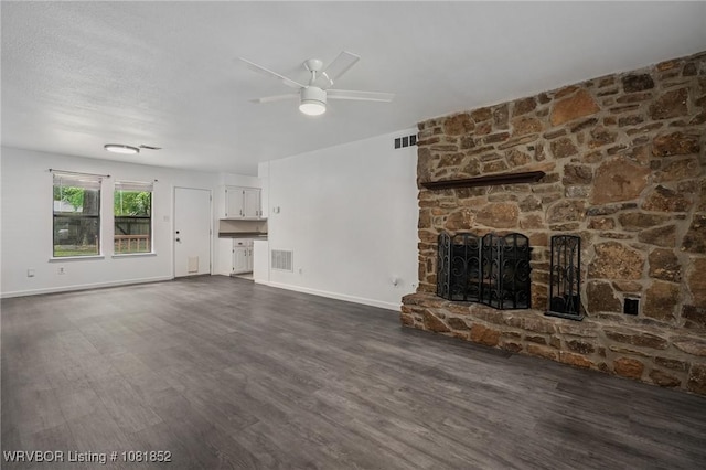 3232 Edinburgh Dr, Fort Smith, AR 72908 - unfurnished living room featuring dark wood finished floors, ceiling fan, and a stone fireplace
