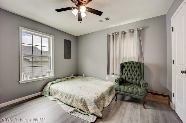 614 12th St, Van Buren, AR 72956 - bedroom with electric panel, wood finished floors, baseboards, and ceiling fan