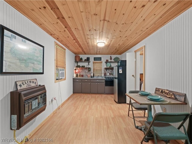 33971 Holson Valley Rd, Wister, OK 74966 - kitchen featuring freestanding refrigerator, heating unit, light wood-style floors, gray cabinets, and open shelves