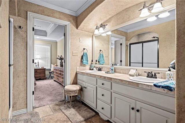 bathroom with a sink, ensuite bath, and crown molding