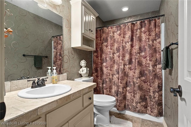 bathroom featuring vanity, toilet, a shower with curtain, and wallpapered walls