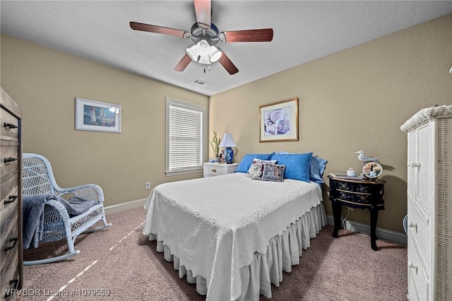 bedroom with visible vents, baseboards, carpet, a textured ceiling, and a ceiling fan