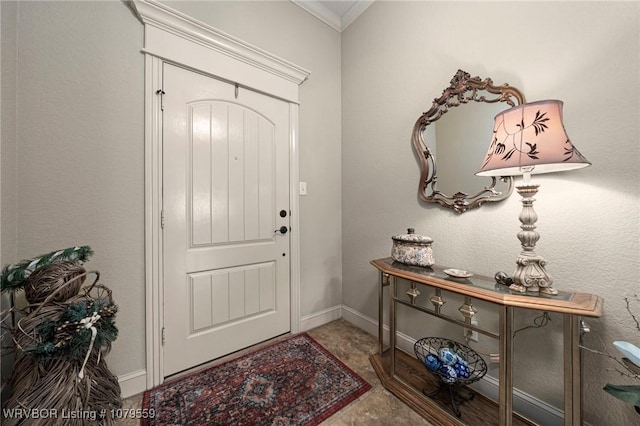 entrance foyer with baseboards and ornamental molding