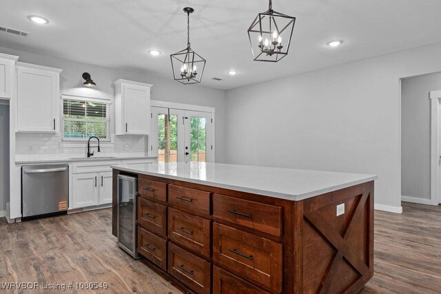 8208 Shaver Rd, Lavaca, AR 72941 - kitchen with tasteful backsplash, beverage cooler, stainless steel dishwasher, a center island, and a notable chandelier