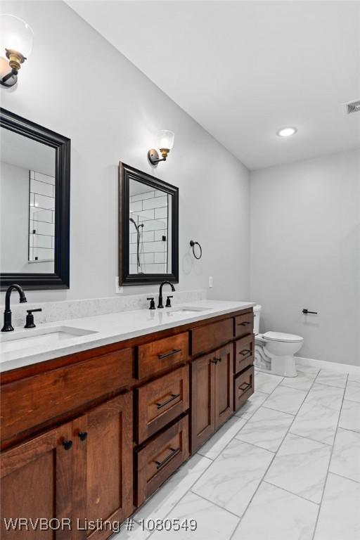 8208 Shaver Rd, Lavaca, AR 72941 - full bathroom featuring double vanity, visible vents, marble finish floor, and a sink