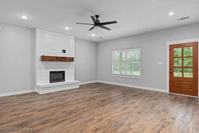 8208 Shaver Rd, Lavaca, AR 72941 - unfurnished living room featuring a wealth of natural light, wood finished floors, ceiling fan, and baseboards
