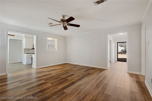 unfurnished room with ceiling fan, crown molding, wood-type flooring, and a textured ceiling