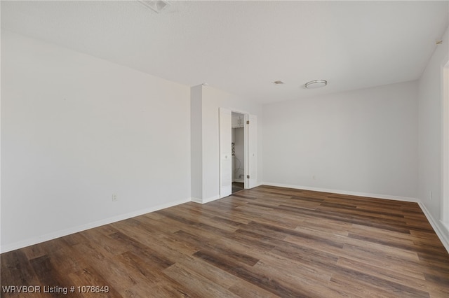 empty room with dark hardwood / wood-style floors