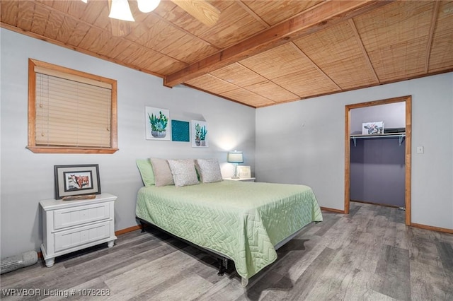 1105 Utah Ranch Rd, Lavaca, AR 72941 - bedroom featuring a wooden ceiling with exposed beams, wood finished floors, a spacious closet, and a closet