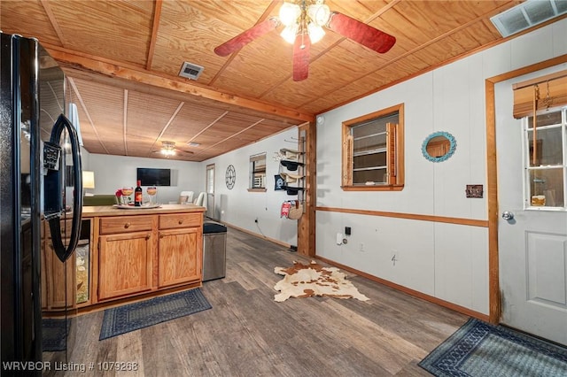 kitchen featuring dark wood-style floors, black fridge with ice dispenser, wooden ceiling, and visible vents