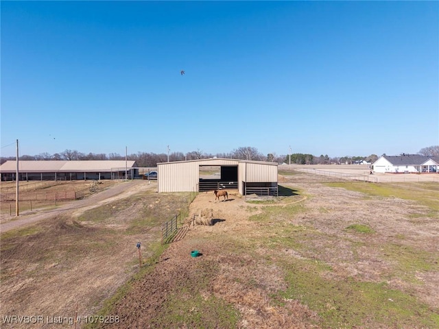 view of yard with an outbuilding and a rural view