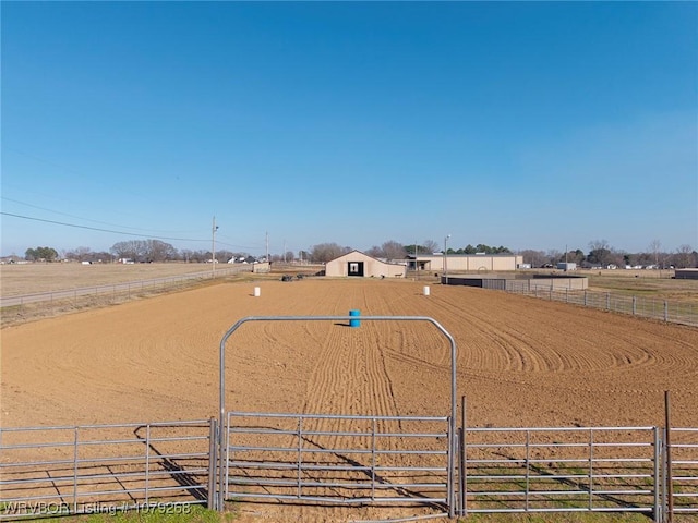 view of home's community with an enclosed area and a rural view