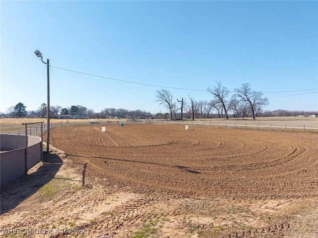 view of yard featuring an enclosed area and a rural view