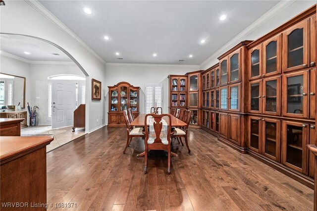 11805 Springridge Dr, Fort Smith, AR 72916 - dining area featuring arched walkways, recessed lighting, dark wood finished floors, and crown molding