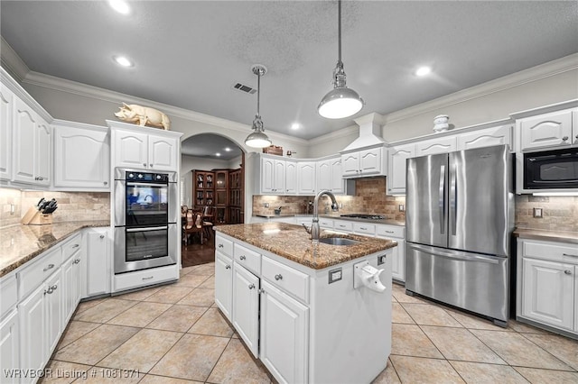 11805 Springridge Dr, Fort Smith, AR 72916 - kitchen featuring appliances with stainless steel finishes, arched walkways, decorative backsplash, white cabinets, and crown molding