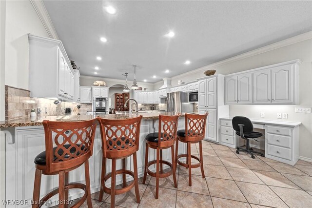 11805 Springridge Dr, Fort Smith, AR 72916 - kitchen with a peninsula, ornamental molding, tasteful backsplash, light stone counters, and a breakfast bar