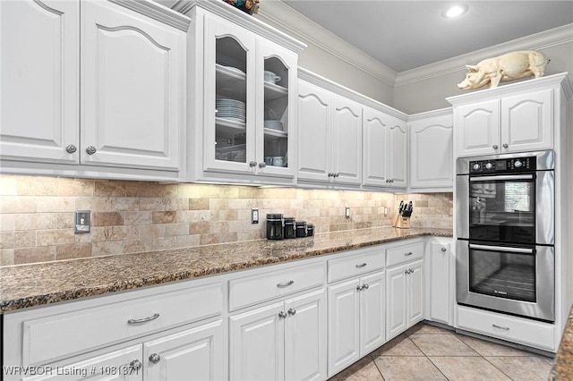 11805 Springridge Dr, Fort Smith, AR 72916 - kitchen with double oven, dark stone countertops, glass insert cabinets, white cabinets, and ornamental molding