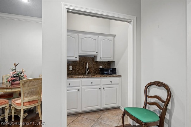 11805 Springridge Dr, Fort Smith, AR 72916 - kitchen featuring tasteful backsplash, white cabinetry, crown molding, dark stone counters, and light tile patterned flooring