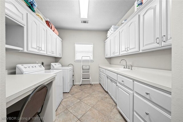 11805 Springridge Dr, Fort Smith, AR 72916 - laundry area featuring independent washer and dryer, cabinet space, and a textured ceiling