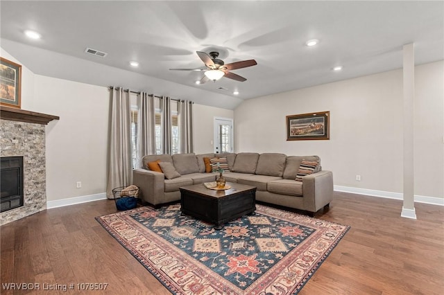 living room featuring visible vents, lofted ceiling, ceiling fan, and wood finished floors