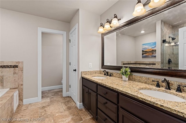 full bath with a sink, baseboards, a garden tub, and a tile shower