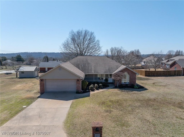 view of front of home with brick siding, driveway, an attached garage, and a front yard