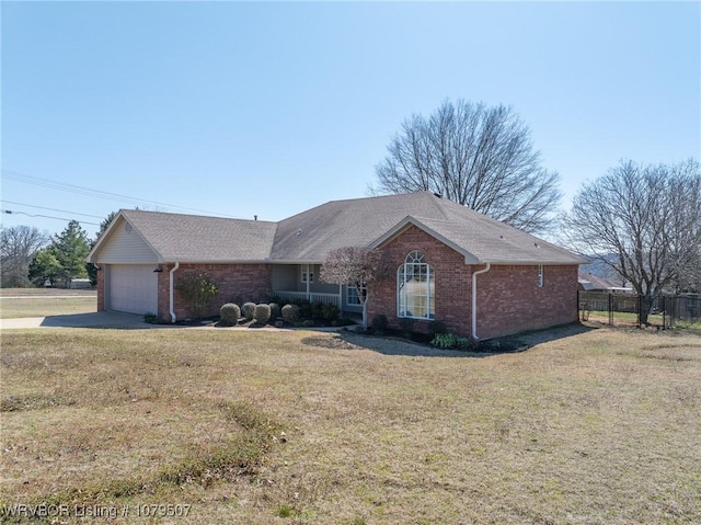 single story home with brick siding, a front yard, a garage, and fence