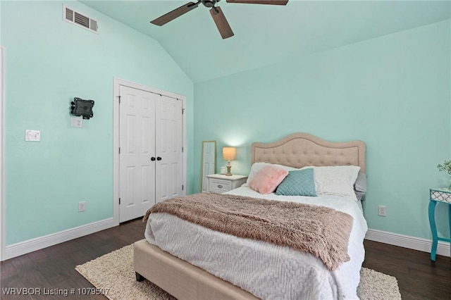 bedroom with visible vents, baseboards, lofted ceiling, and wood finished floors