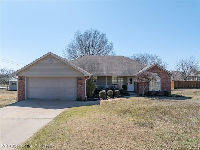 ranch-style house featuring driveway, a porch, a front yard, a garage, and brick siding