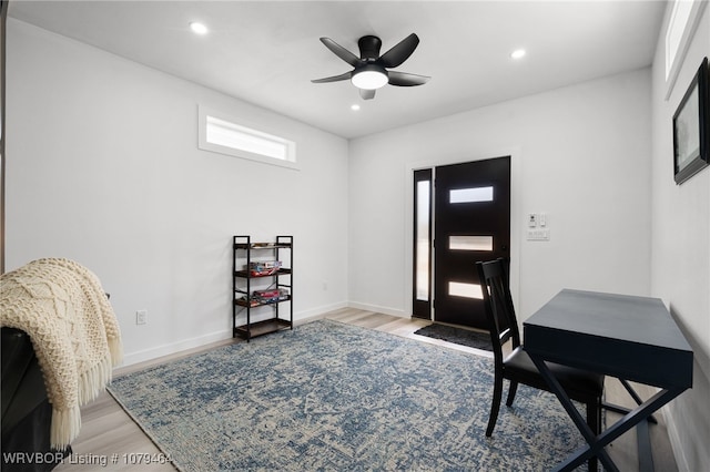 foyer with light wood-type flooring, baseboards, and recessed lighting