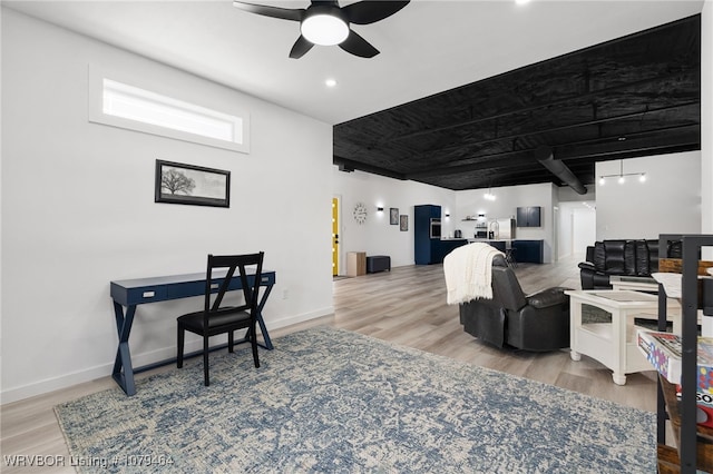 office area with wood finished floors, a ceiling fan, and baseboards