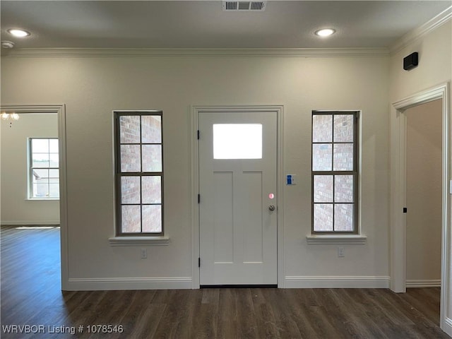 foyer entrance with dark wood-type flooring and crown molding