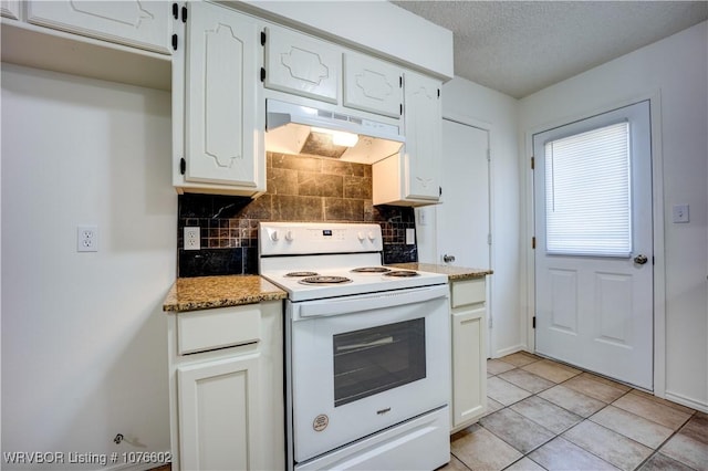 kitchen with electric range, light stone counters, white cabinetry, and light tile patterned flooring